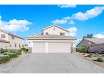 Inviting two-story home featuring a three-car garage and manicured landscaping at 2682 Korea Ct, Henderson, NV 89052