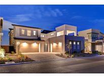 Stunning modern home showcasing a three-car garage and landscaped front yard with a paved driveway at 472 Windstone Crest Ave, Las Vegas, NV 89138