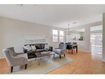 Inviting living room boasts stylish seating and seamless flow to the dining area, perfect for entertaining at 5033 Wild Buffalo Ave, Las Vegas, NV 89131