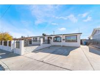 Charming single-story home featuring a gated front yard and a spacious driveway at 6425 Evergreen Ave, Las Vegas, NV 89107