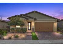 Charming single-story home featuring desert landscaping, a brick driveway, and a two-car garage at 732 Rosewater Dr, Henderson, NV 89011