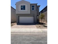 Two-story home with a neutral color scheme, a two-car garage, and low-maintenance landscaping at 9989 River Corral St, Las Vegas, NV 89166