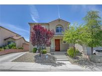 Inviting two-story home featuring well-maintained landscaping and a charming front entrance at 2641 Vendange Pl, Henderson, NV 89044