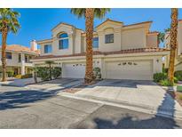 Two-story townhome with desert landscaping and a two-car garage in a sunny neighborhood at 5412 Harmony Green Dr # 101, Las Vegas, NV 89149