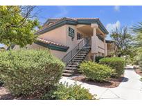Exterior view of a multi-Gathering residential building featuring lush landscaping and stairwell at 8410 Eldora Ave # 2045, Las Vegas, NV 89117