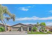 Charming single-story home featuring desert landscaping, a spacious three-car garage, and a welcoming facade at 8208 Flowing Rapids Ct, Las Vegas, NV 89131