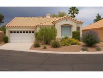 Charming single-story home with a two car garage, desert landscaping and a tile roof at 9532 Calico Garden Ave, Las Vegas, NV 89134