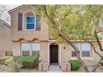 Inviting two-story home featuring desert landscaping, arched entry, and shuttered window at 11036 Mount Hunter St, Las Vegas, NV 89179
