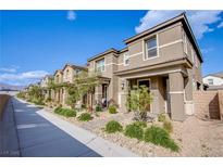 Charming row of two-story townhomes with well-manicured landscaping and covered entryways at 4533 Queens Hill St, North Las Vegas, NV 89031