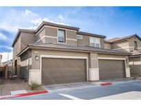 Charming townhome with a two-car garage and neutral-toned stucco exterior, perfect for modern living at 4533 Queens Hill St, North Las Vegas, NV 89031