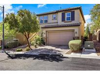 Charming two-story home featuring a tile roof, attached garage, and manicured landscaping at 10433 Mount Washington Ave, Las Vegas, NV 89166