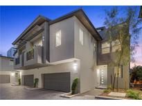 Modern two-story townhome featuring a two-car garage and contemporary architectural details at 11315 Gravitation Dr, Las Vegas, NV 89135