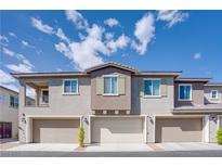 Modern townhouse exterior with three garage doors and neutral color palette under blue sky at 25 Barbara Ln # 57, Las Vegas, NV 89183