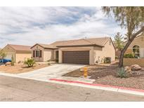 Charming single-story home featuring desert landscaping and a two-car garage at 2605 Memphis Ave, Henderson, NV 89052