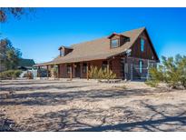 Charming log cabin-style home with a covered porch, offering rustic charm and outdoor living space at 3900 W Landberg Ave, Las Vegas, NV 89141