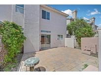 Relaxing outdoor patio featuring pavers, plants, and a quaint glass table with a serene ambiance at 5331 Heatherbrook Cir, Las Vegas, NV 89120