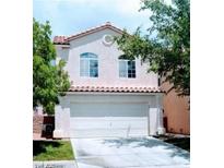 Charming two-story home featuring a spacious two-car garage and well-maintained landscaping at 5811 Pack Trl, Las Vegas, NV 89118