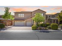 Charming two-story home featuring a three-car garage and beautifully landscaped front yard at 6917 Puetollano Dr, North Las Vegas, NV 89084