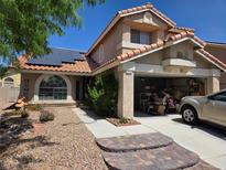 Charming two-story home with desert landscaping, solar panels, and an attached two-car garage at 8324 Brittany Harbor Dr, Las Vegas, NV 89128