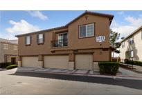 Inviting townhome featuring attached garages and exterior with neutral color palette at 9121 Ripple Ridge Ave # 101, Las Vegas, NV 89149