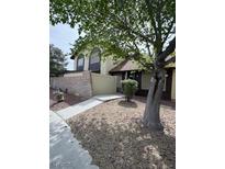 Inviting two-story home with a well-maintained yard, mature tree, and partially-enclosed front patio at , Las Vegas, NV 89102