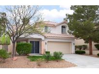 Two-story home featuring desert landscaping, a two-car garage and a beautiful tile roof at 10413 Mountain Lodge Pl, Las Vegas, NV 89144