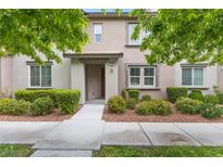 Charming two-story home with a landscaped yard featuring lush greenery and a welcoming entrance at 11408 Newton Commons Dr # 104, Las Vegas, NV 89135