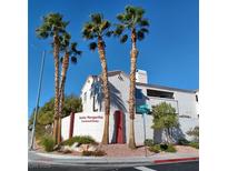 Santa Margarita Condominiums exterior view with palm trees and well-maintained landscaping at 1621 Sandecker Ct # 104, Las Vegas, NV 89146