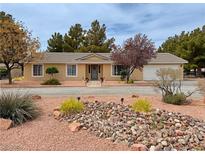 Charming home featuring desert landscaping with rock features and a well-maintained front yard at 3580 Unicorn Ave, Pahrump, NV 89048