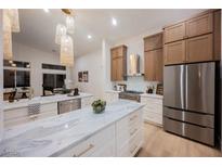 Bright kitchen featuring a marble island, stainless steel appliances, and pendant lighting at 4065 Genoa Dr, Las Vegas, NV 89141