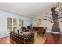 Bright living room featuring large windows and a unique tree mural on the wall at 5010 Mick Pl, Las Vegas, NV 89103