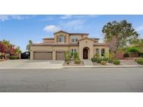 Stunning two-story home features a three-car garage, arched entryway, and well-maintained landscaping at 549 Via Balizan Ave, Las Vegas, NV 89123