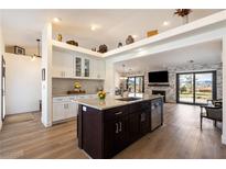 Open-concept kitchen featuring an island, granite counters, stainless appliances and bright natural light at 5570 N Nopah Vista Ave, Pahrump, NV 89060
