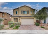 Charming two-story home with a paved driveway, complemented by manicured landscaping and a neutral color scheme at 7109 Red Gulch St, North Las Vegas, NV 89084