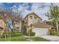 Charming two-story home featuring a well-manicured lawn and a two-car garage at 916 Pro Players Dr, Las Vegas, NV 89134