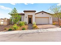 Charming single-story home featuring a well-manicured front yard and a two car garage at 31 Autumn Palm Ave, Henderson, NV 89011