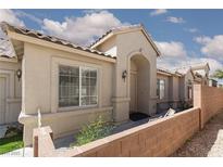 Charming single-story home featuring a welcoming front porch and desert landscaping under a partly cloudy sky at 2691 Rimpacific Cir, Las Vegas, NV 89146