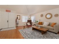 Bright living room with hardwood floors, neutral decor and natural light at 2691 Rimpacific Cir, Las Vegas, NV 89146