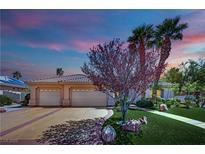 Charming single-story home showcasing a well-manicured lawn, complemented by mature trees and a convenient two-car garage at 4722 Blue Mesa Way, Las Vegas, NV 89129