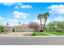 Charming single-story home showcasing a well-manicured lawn, lush greenery, and a three-car garage at 4722 Blue Mesa Way, Las Vegas, NV 89129