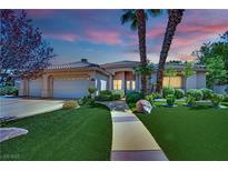 Beautiful single-story home with a well-manicured lawn, lush landscaping, and a charming walkway at 4722 Blue Mesa Way, Las Vegas, NV 89129