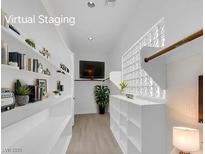 Bright hallway featuring built-in shelves, a TV, and a decorative glass block window at 4722 Blue Mesa Way, Las Vegas, NV 89129