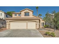 Charming two-story home with a stucco exterior, desert landscaping, and a spacious three-car garage at 8447 Amherst Valley St, Las Vegas, NV 89123