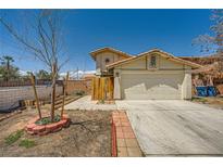 Charming two-story home with a two-car garage and desert landscaping in a bright, sunny setting at 100 Underhill Ct, Las Vegas, NV 89145
