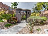 Charming entrance gate with decorative ironwork and lush landscaping creates a welcoming feel at 10616 Olympic Pine Dr, Las Vegas, NV 89135