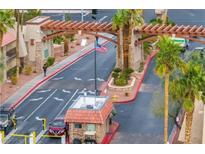Guarded community entrance with mature landscaping and an American flag at 4421 Alexis Dr # 429, Las Vegas, NV 89103