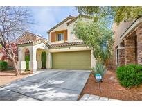 Charming two-story home featuring a two-car garage, stucco facade, and well-maintained landscaping at 10235 Headrick Dr, Las Vegas, NV 89166