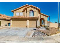 Inviting two-story home with a well-manicured yard, desert landscaping, and a two-car garage at 1532 Ascension Cir, North Las Vegas, NV 89031