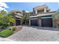 Stunning contemporary home featuring a stylish paved driveway and stone accents at 29 Owl Ridge Ct, Las Vegas, NV 89135