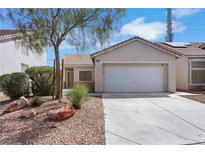 Charming single-story home featuring a two-car garage, desert landscaping, and a well-maintained front yard at 6314 Shadow Moon Pl, North Las Vegas, NV 89031